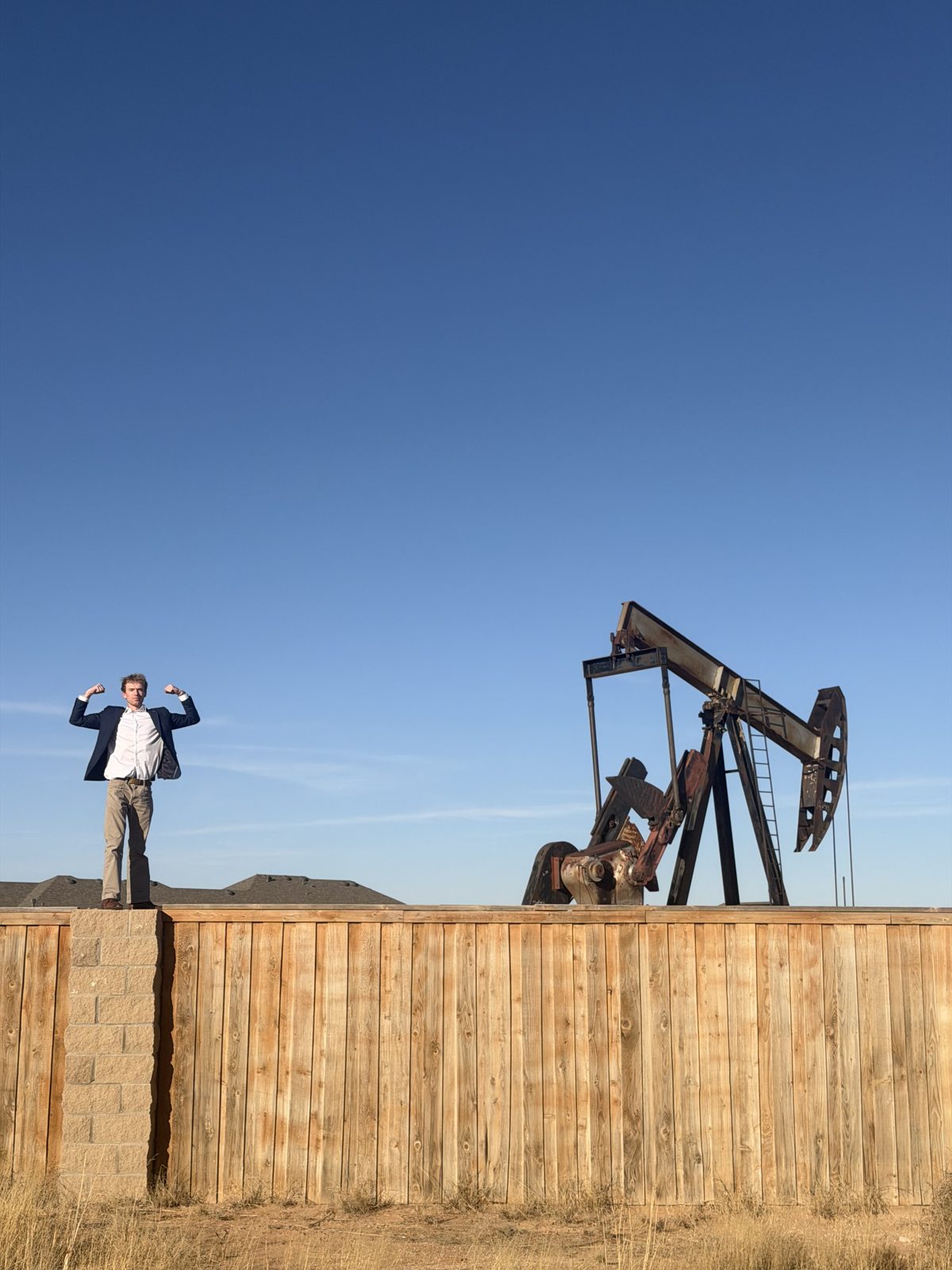 Aidan Isaac in front of a pump jack